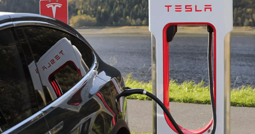 Tesla At A Charging Station - Tesla Road Trip Tips