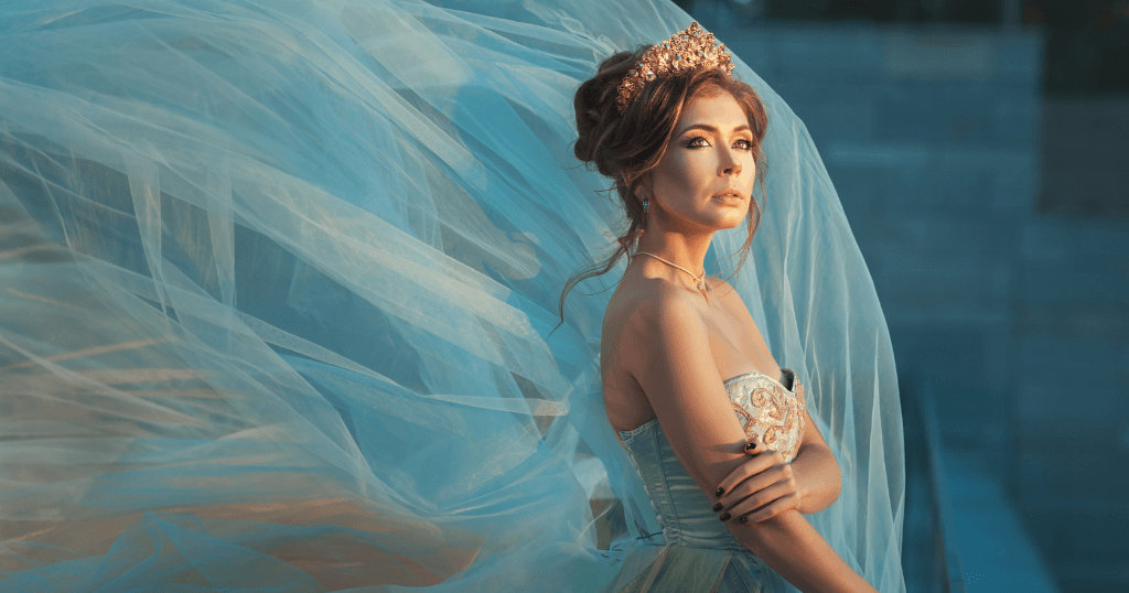 Queen against blue sheer fabric blowing